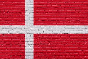 A collection of European national flags including Denmark, displayed on a textured brick wall with a patriotic and grunge aesthetic photo