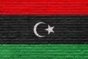 libya flags painted on an old wooden plank wall with a grunge, abstract texture photo
