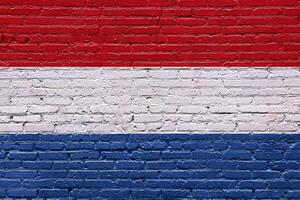 Red brick wall with netherland flag and white brick section photo
