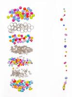 Set for design of colored beads on a white background for the signature, rings, beads, for example photo