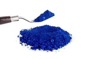 Bright Blue Pigment on a Palette With a Tool for Mixing and Application photo
