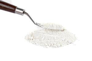 White Powder With a Metal Spatula on a Clean Surface in a Bright Setting photo