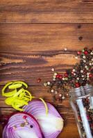 DIFFERENT SPICES FOR COOKING FOOD ON A DARK WOODEN BACKGROUND photo