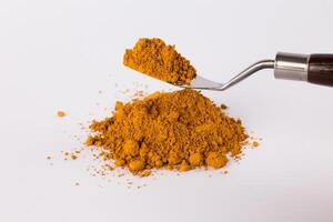ochre pigment on a white background photo