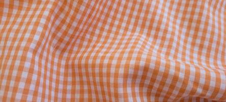 checkered picnic blanket fluttering on a sunny day photo
