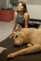 A woman practices yoga on a mat photo