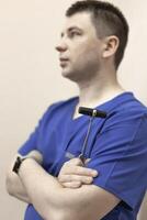 a male doctor holds a reflex nerve tapping instrument in his hand photo
