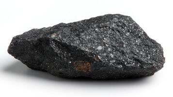 A dark, textured rock with a shiny surface. photo