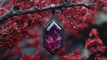 A pendant featuring a purple crystal on a branch. photo