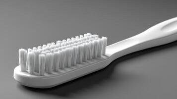 A simple white toothbrush on a gray background. photo