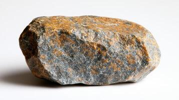 A textured rock with orange and gray hues. photo