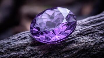 A sparkling purple gemstone on a wooden surface. photo