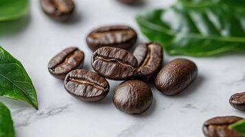 Coffee beans on a marble surface with leaves. photo