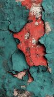 Cracked wall revealing red and teal layers. photo