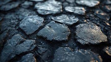 Close-up of textured, dark surface with cracks. photo
