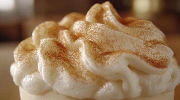 Creamy dessert topped with whipped cream and cinnamon. photo