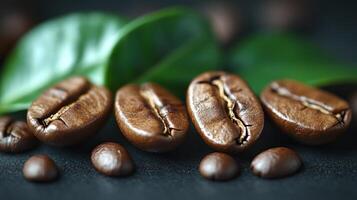 closeup shot Coffee beans with green leaves on a dark surface. photo