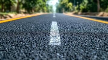 Close-up view of a road with trees in background. photo