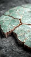 Cracked green stone surface with textured details. photo