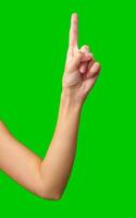 Hand gesture indicating number one with a green background during a creative or educational activity photo