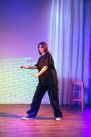 Dancer performs contemporary style in a colorful studio setting during a dance rehearsal photo