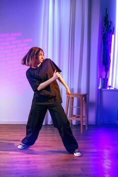 Dynamic urban dance performance highlighting expression and movement in modern studio setting during evening hours photo