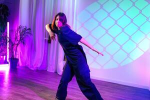 Dance performance showcases expressive movement under colorful lights in a modern venue photo