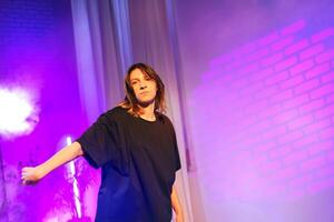 Performance art showcasing an expressive dancer in a vibrant, illuminated setting during an evening event photo
