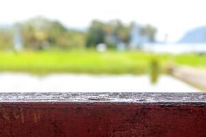 Wooden base with blurred background of natural scenery of rice fields and hills photo