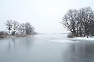 Serene Winter Landscape Frozen River with Bare Trees. A tranquil scene of a frozen waterway bordered by leafless trees under a pale winter sky. photo
