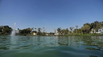 Boats with tourists on the city lake float around the fountains. Sunny summer day video