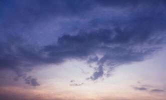 A captivating image of a vibrant sunset sky transitioning from warm orange hues to deep blue. photo
