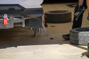 Race car maintenance in pit stop with tools mechanic working on photo