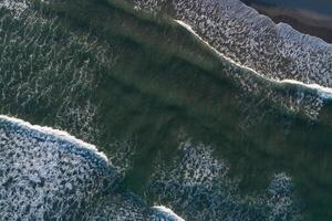 drone aerial directly above view of the waves on the shore of a beach on a day of high tides photo