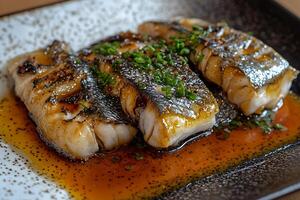 Close-up of Delicious Grilled Fish Fillet with Glaze and Green Onions. photo