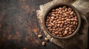 Pinto Beans in Rustic Bowl Overhead Close Up of Dried Beans on Burlap. photo