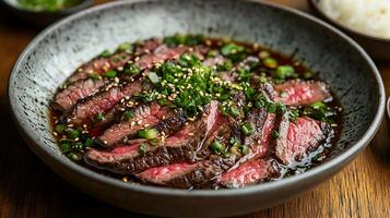 Close Up of Sliced Beef in a Savory Sauce, Garnished with Sesame Seeds and Green Onions. photo