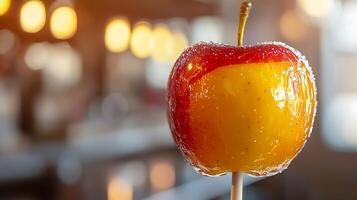 Close up of a Candy Apple on a Stick, Glowing Warm Lights in Background. photo