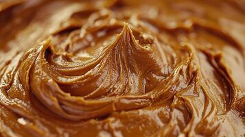 Close Up of Creamy, Swirled Caramel Sauce Texture. A Detailed Image of Rich Brown Caramel. photo