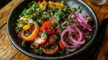 Fresh Tomato and Red Onion Salad with Cilantro in a Dark Bowl. photo