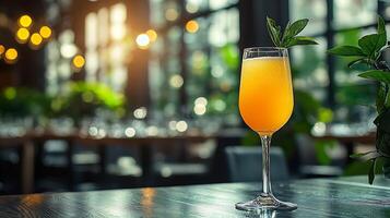 Refreshing Orange Cocktail in a Champagne Flute on a Restaurant Table. photo