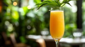 Refreshing Yellow Cocktail in a Tall Glass with Tropical Leaves. A close up image of a vibrant, bubbly drink perfect for summer. photo