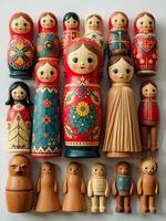 colorfu traditionally painted matryoshka dolls are arranged on a light surface, some accompanied by small decorative natural elements photo