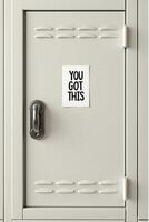 A light gray metal locker features silver handle and a white sticker that boldly states, YOU GOT THIS photo