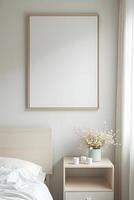 A large, white-rectangular canvas hang above a bed and a small nightstand photo