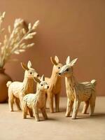 funny handcrafted straw deer figurines stand closely together on a neutral surface photo