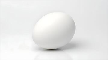 A single white egg standing on a white surface, casting a soft shadow, highlighting simplicity and purity. photo