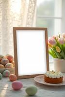 one blank wooden frame adorned with colorful Easter eggs, a festive Easter cake, and a vase of tulips, creating a warm and inviting springtime scene photo