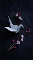 White origami bird presents fragile and serene image, contrasting against dark backdrop, blooming with delicate flowers, creating beauty photo