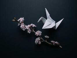 White origami paper bird with flower branch looks delicate and fragile against dark background, evoking sense of peace and simple beauty photo